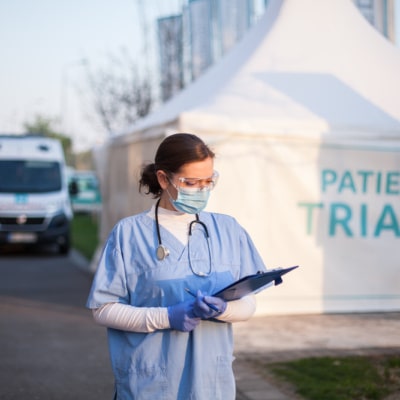 Employee outside temporary triage centre