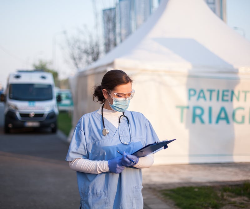 Employee outside temporary triage centre