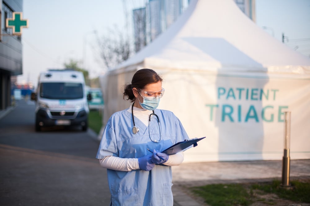 Employee outside temporary triage centre