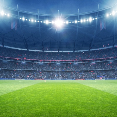 Football Stadium Under the Spotlights with Cheerful Atmosphere