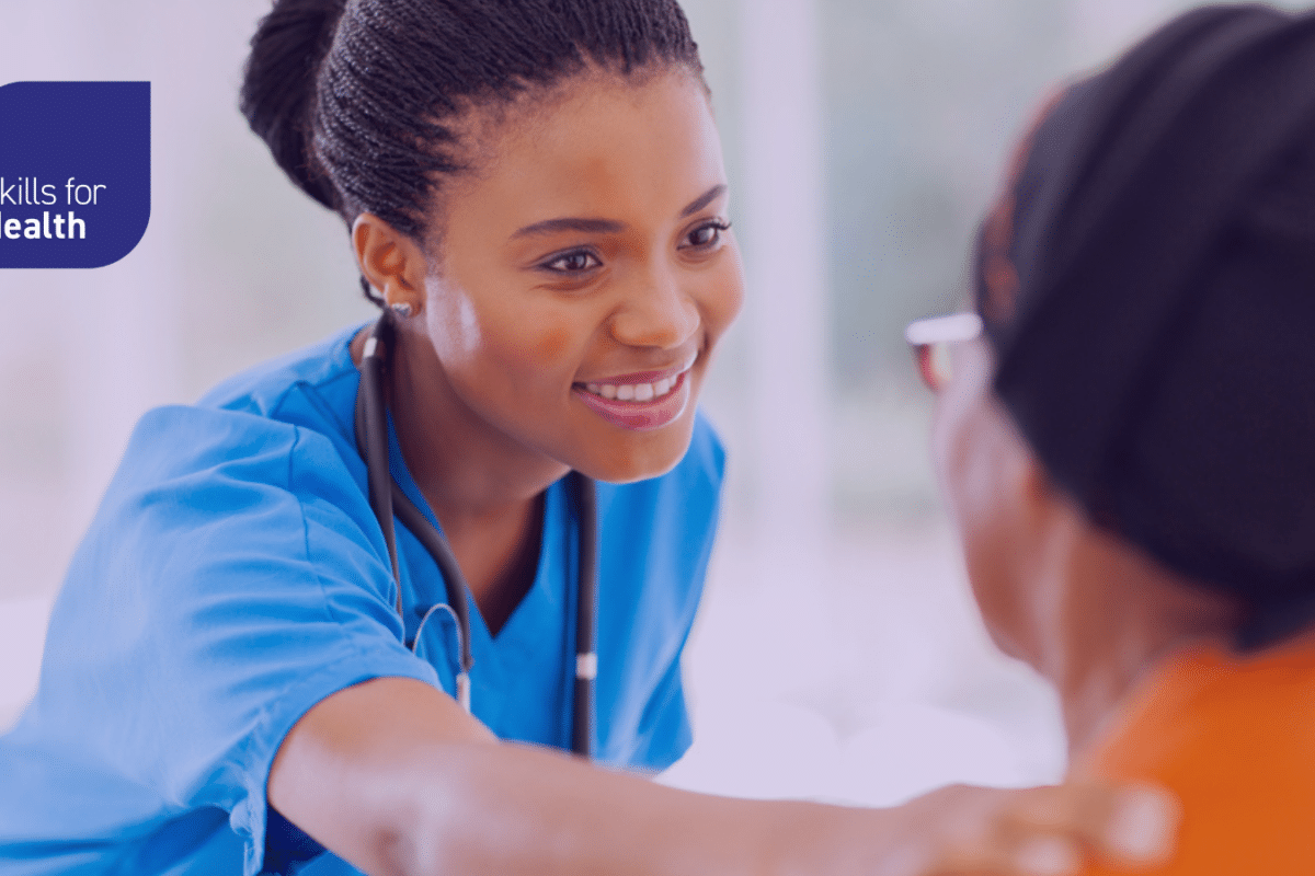 Healthcare worker supporting patient with hand on their shoulder