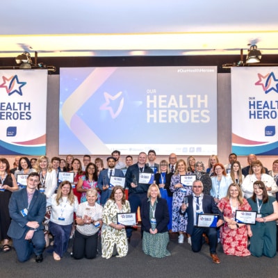 Group photo of winners and presenters on stage at Our Health heroes 2025