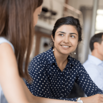 Smiling apprentice speaking to a colleague