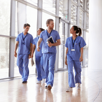 A group of healthcare workers walking together in a hospital setting
