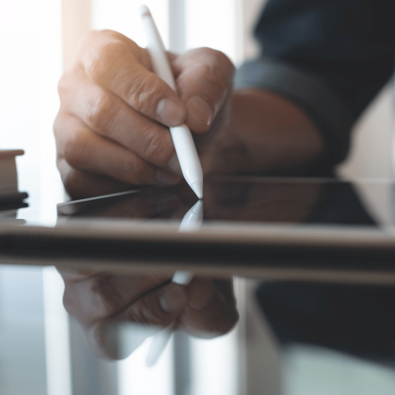 Person writing using iPad/tablet