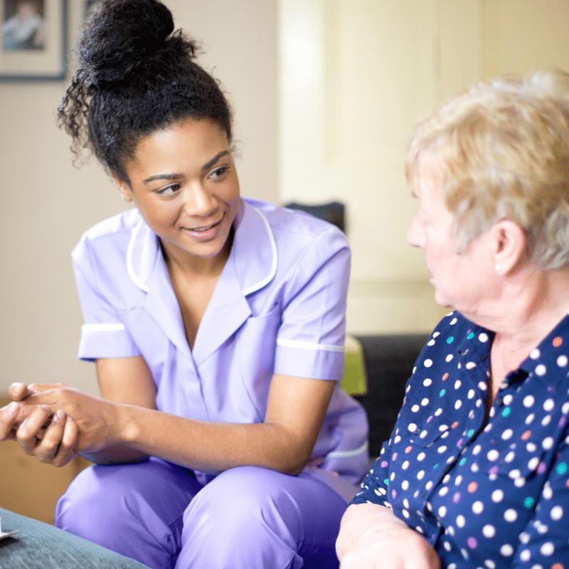 Care worker chatting with elderly patient