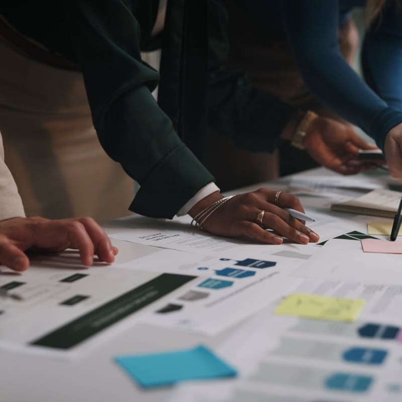 people leaning over report documents