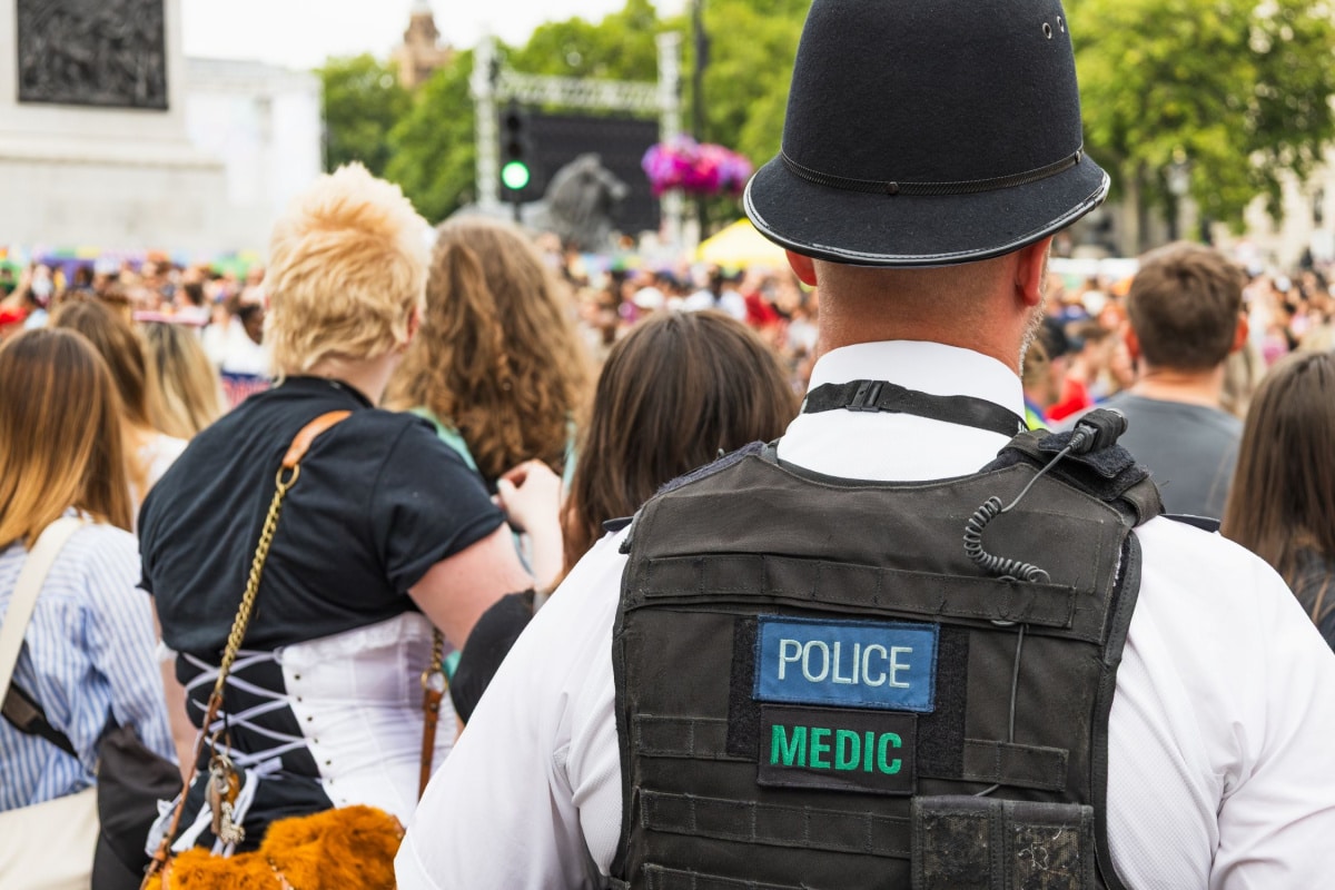 back of policeman in crowd