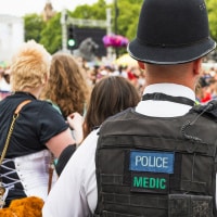 back of policeman in crowd
