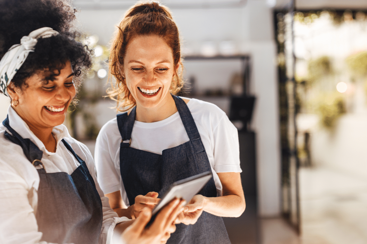 Front of house hospitality staff looking at a tablet together